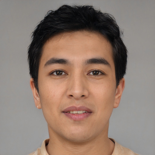 Joyful asian young-adult male with short  black hair and brown eyes