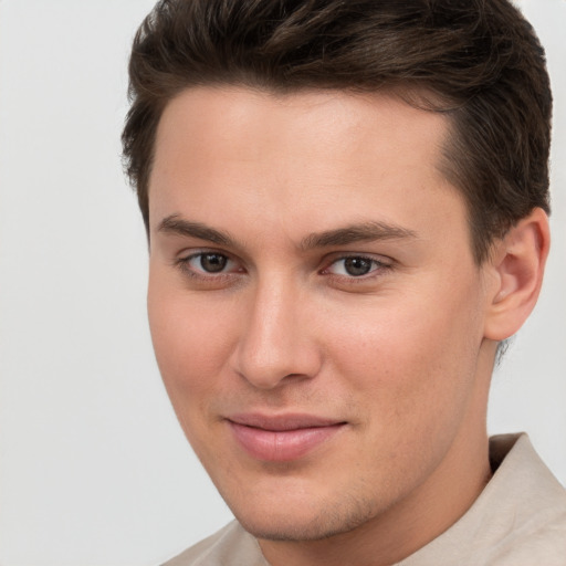 Joyful white young-adult male with short  brown hair and brown eyes