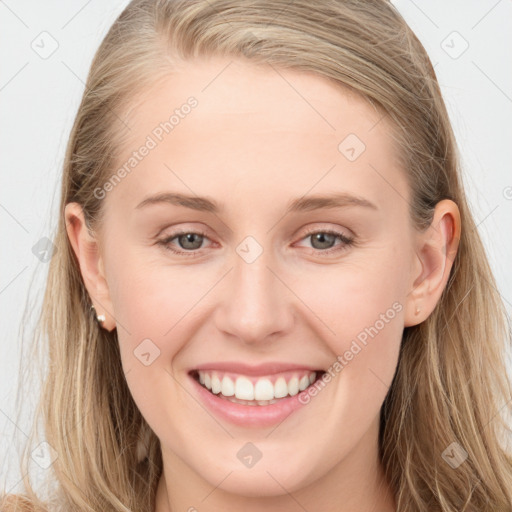 Joyful white young-adult female with long  brown hair and blue eyes