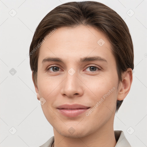 Joyful white young-adult female with short  brown hair and grey eyes