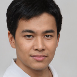 Joyful asian young-adult male with short  brown hair and brown eyes