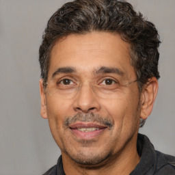 Joyful white adult male with short  black hair and brown eyes