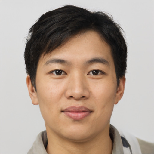 Joyful asian young-adult male with short  brown hair and brown eyes