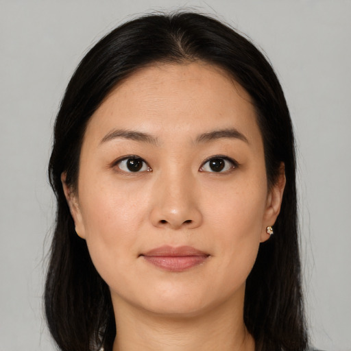 Joyful asian young-adult female with long  brown hair and brown eyes