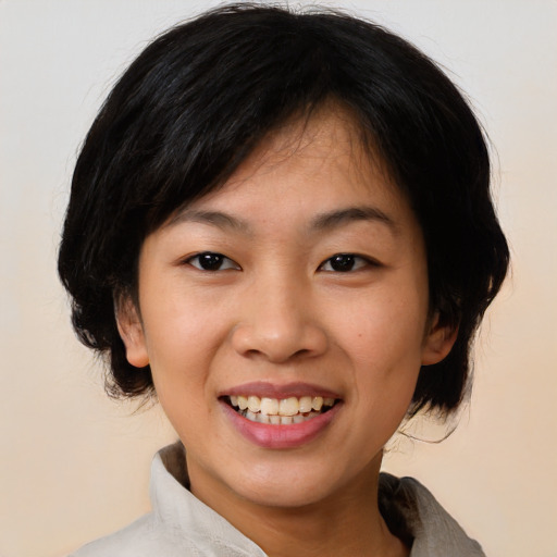 Joyful asian young-adult female with medium  black hair and brown eyes