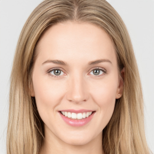 Joyful white young-adult female with long  brown hair and grey eyes