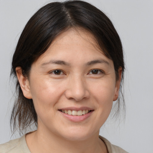 Joyful white adult female with medium  brown hair and brown eyes