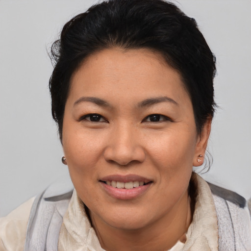 Joyful asian adult female with short  brown hair and brown eyes