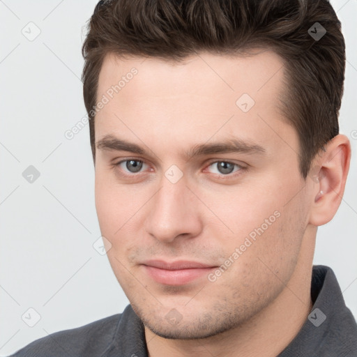 Joyful white young-adult male with short  brown hair and brown eyes