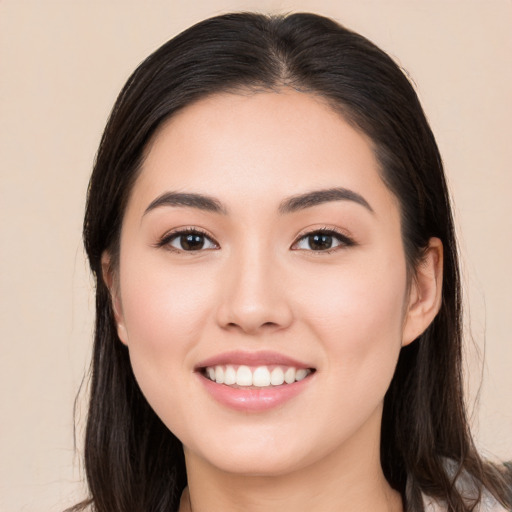 Joyful white young-adult female with long  black hair and brown eyes