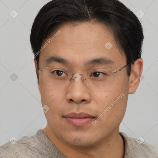 Joyful asian young-adult male with short  brown hair and brown eyes