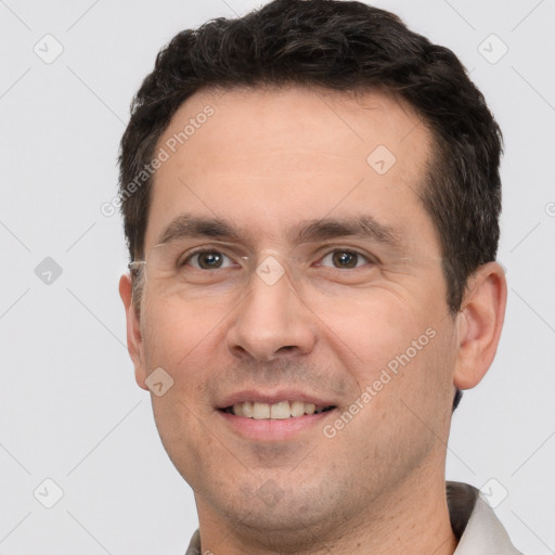 Joyful white adult male with short  brown hair and brown eyes