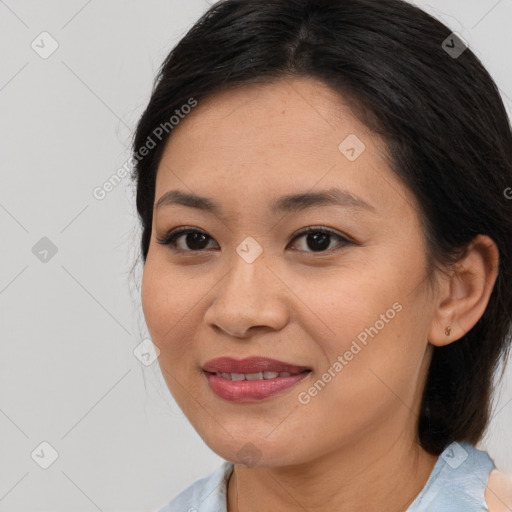 Joyful asian young-adult female with medium  brown hair and brown eyes