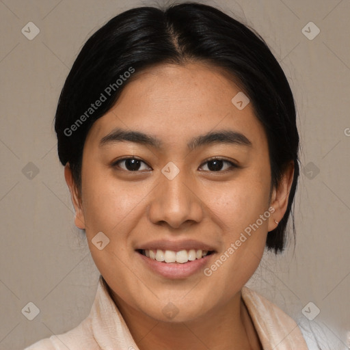 Joyful asian young-adult female with medium  black hair and brown eyes