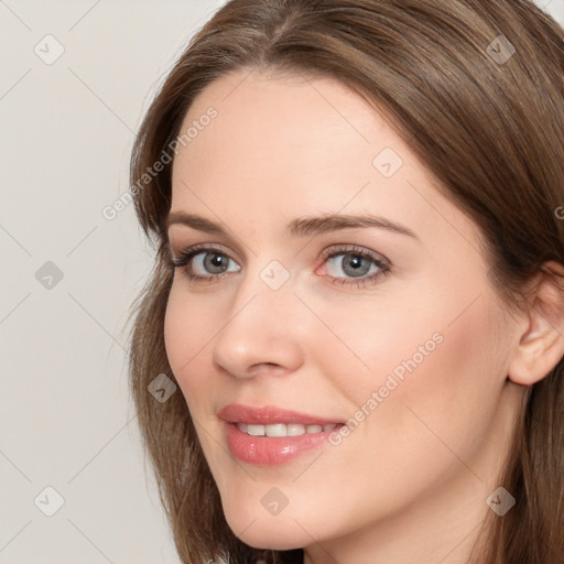 Joyful white young-adult female with long  brown hair and grey eyes