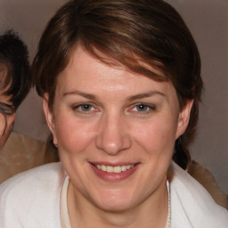 Joyful white adult female with medium  brown hair and brown eyes