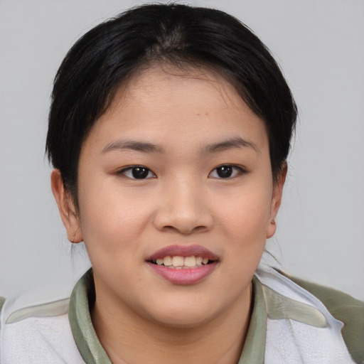 Joyful asian young-adult female with short  brown hair and brown eyes