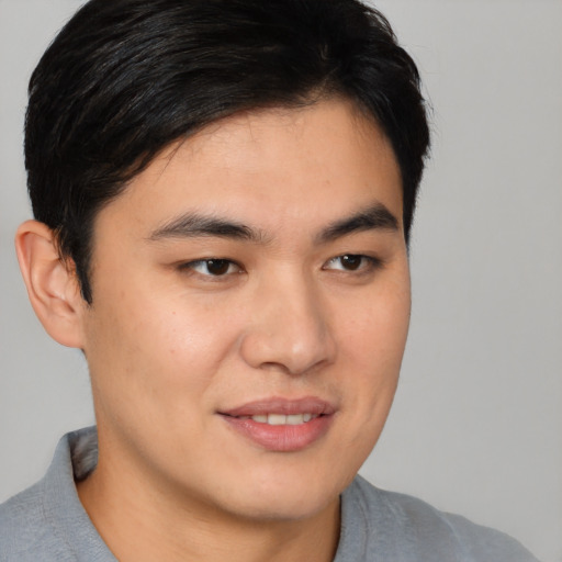 Joyful asian young-adult male with short  brown hair and brown eyes