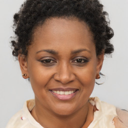 Joyful black adult female with short  brown hair and brown eyes
