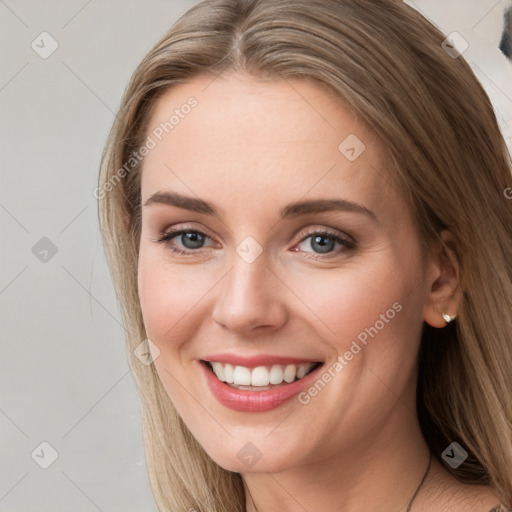 Joyful white young-adult female with long  brown hair and blue eyes