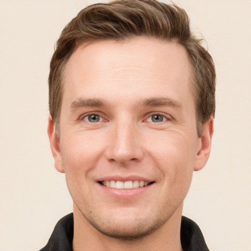 Joyful white young-adult male with short  brown hair and grey eyes