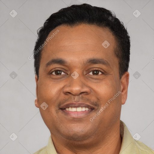 Joyful latino young-adult male with short  brown hair and brown eyes