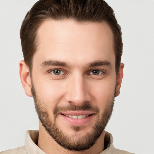 Joyful white young-adult male with short  brown hair and brown eyes