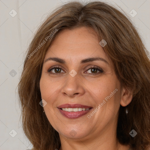 Joyful white adult female with long  brown hair and brown eyes