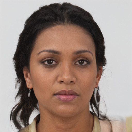 Neutral black young-adult female with medium  brown hair and brown eyes