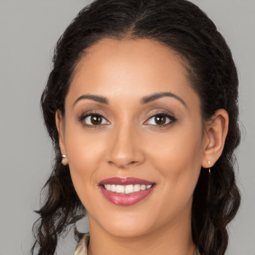 Joyful latino young-adult female with long  brown hair and brown eyes