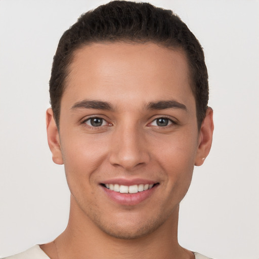 Joyful white young-adult male with short  brown hair and brown eyes