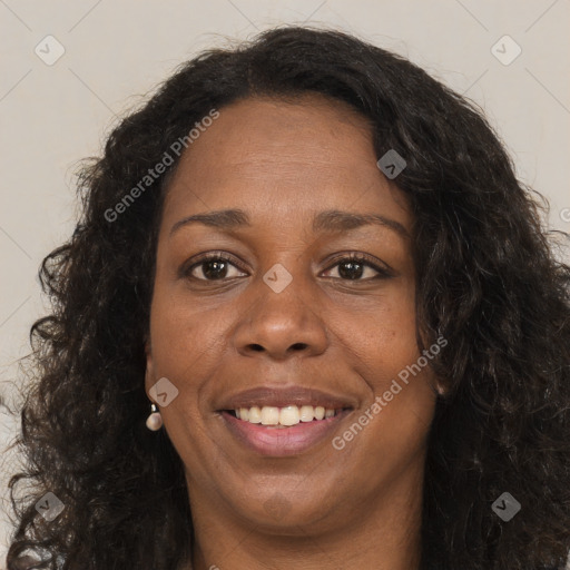 Joyful black adult female with long  brown hair and brown eyes