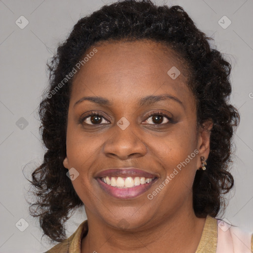 Joyful black young-adult female with long  brown hair and brown eyes