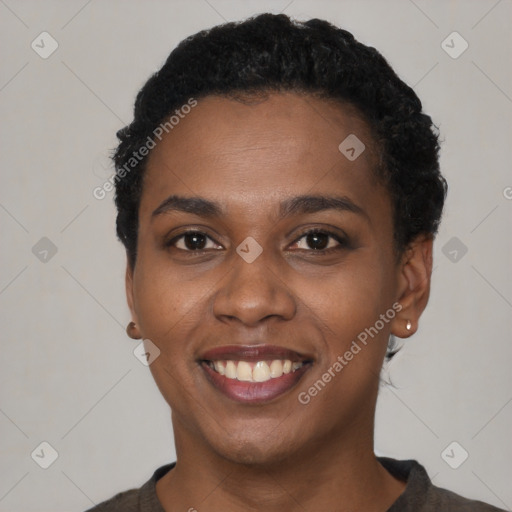 Joyful black young-adult female with short  black hair and brown eyes