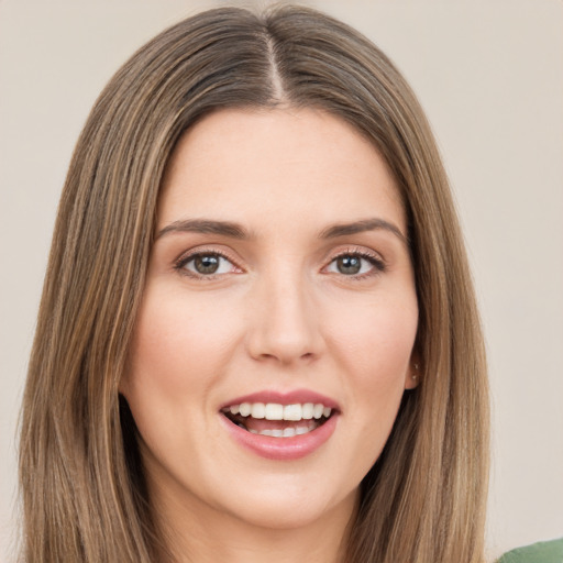 Joyful white young-adult female with long  brown hair and green eyes