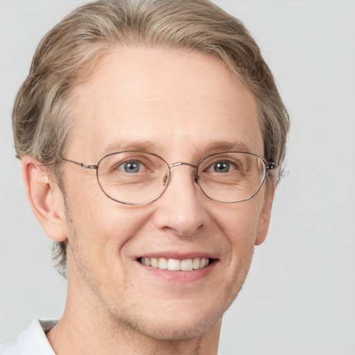 Joyful white middle-aged male with short  brown hair and grey eyes