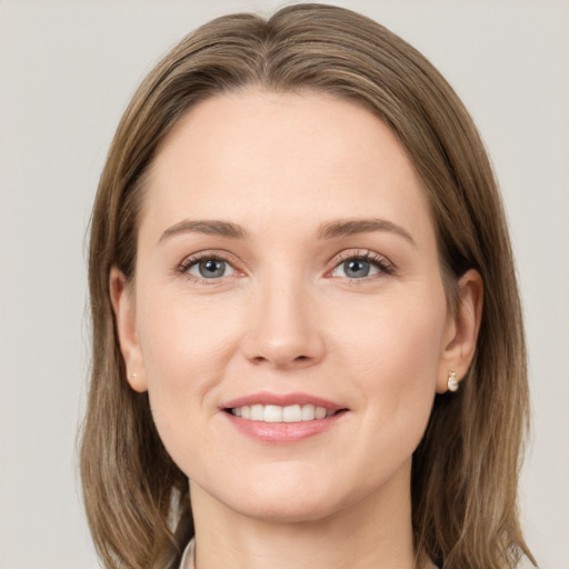 Joyful white young-adult female with medium  brown hair and grey eyes