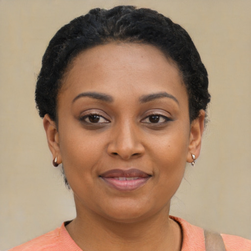 Joyful latino young-adult female with short  black hair and brown eyes