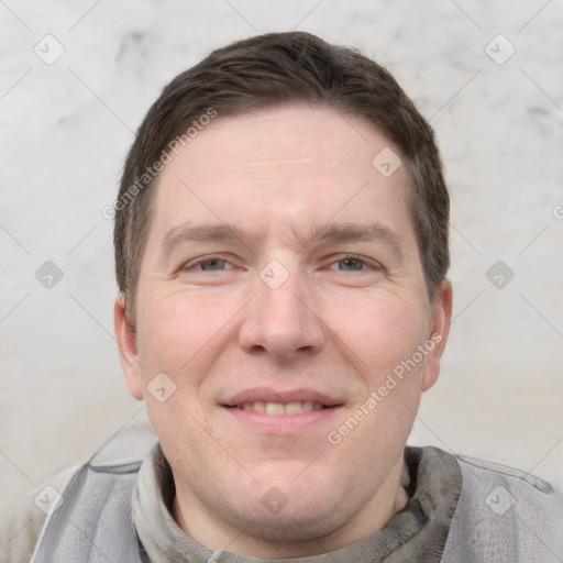 Joyful white adult male with short  brown hair and grey eyes