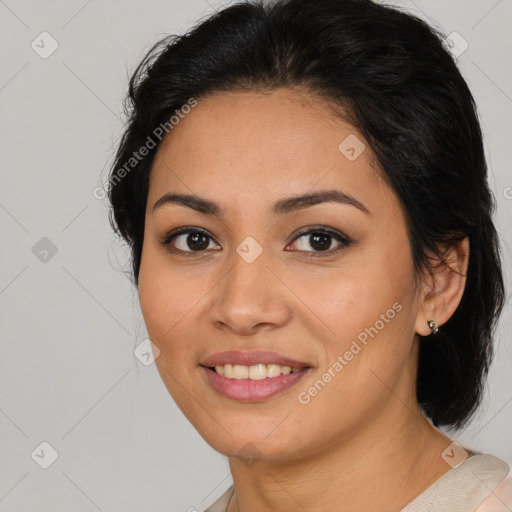 Joyful latino young-adult female with medium  brown hair and brown eyes