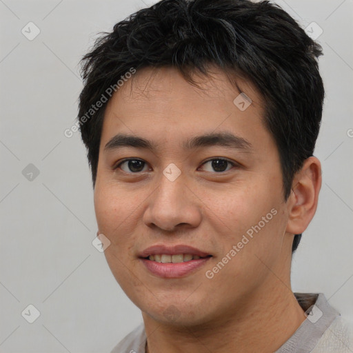 Joyful asian young-adult male with short  brown hair and brown eyes