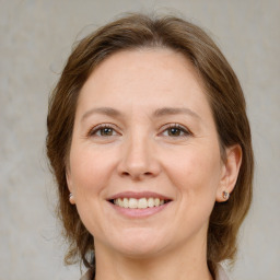 Joyful white adult female with medium  brown hair and grey eyes