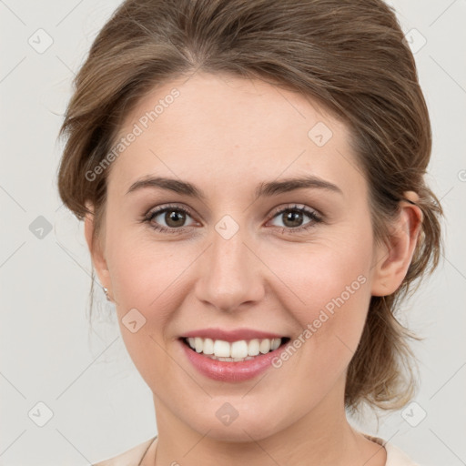 Joyful white young-adult female with medium  brown hair and green eyes