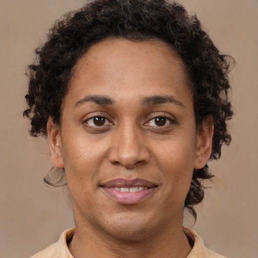Joyful black young-adult female with short  brown hair and brown eyes