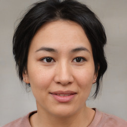 Joyful asian young-adult female with medium  brown hair and brown eyes