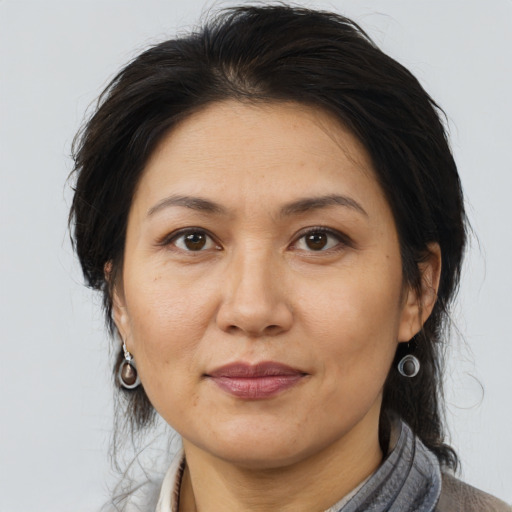 Joyful asian adult female with medium  brown hair and brown eyes