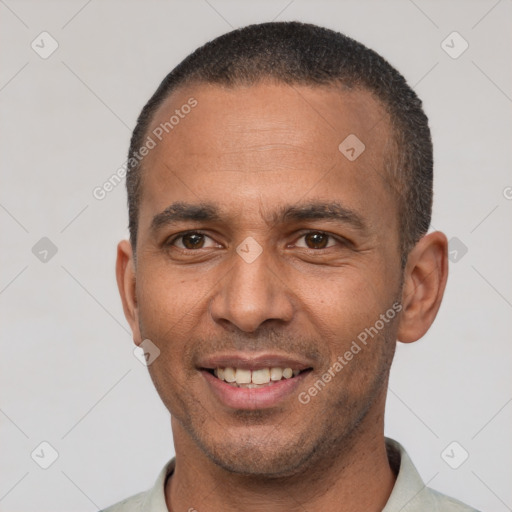 Joyful latino adult male with short  black hair and brown eyes