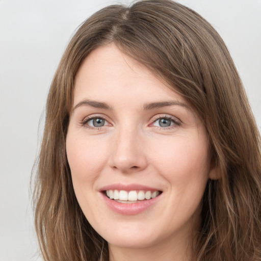 Joyful white young-adult female with long  brown hair and grey eyes