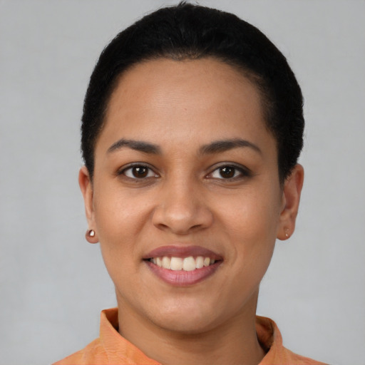Joyful latino young-adult female with short  black hair and brown eyes
