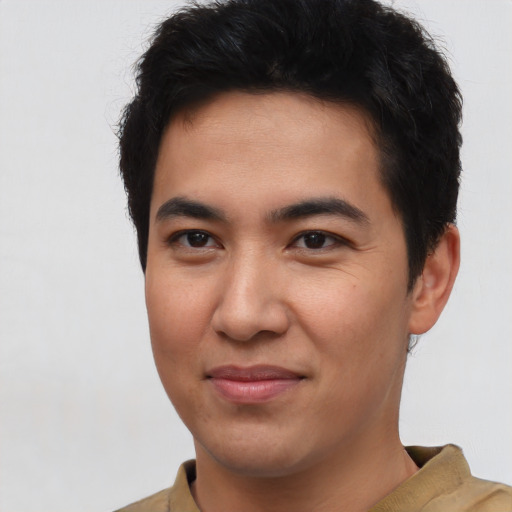 Joyful latino young-adult male with short  brown hair and brown eyes